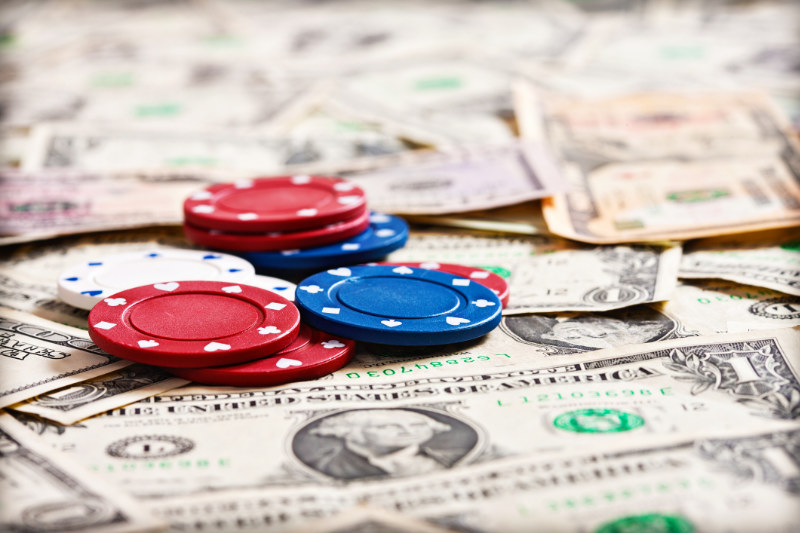 Poker chips on top of American Dollar bills